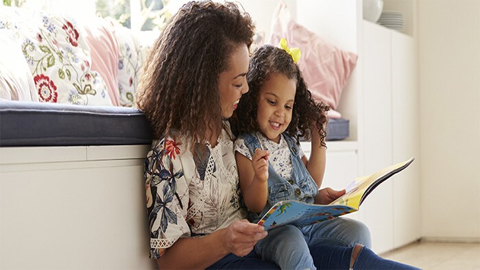 mother and daughter reading a book 